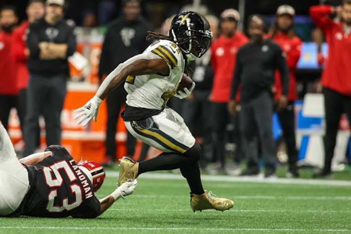 Nov 26, 2023; Atlanta, Georgia, USA; New Orleans Saints running back Alvin Kamara (41) runs the ball past Atlanta Falcons linebacker Nate Landman (53) in the second half at Mercedes-Benz Stadium.